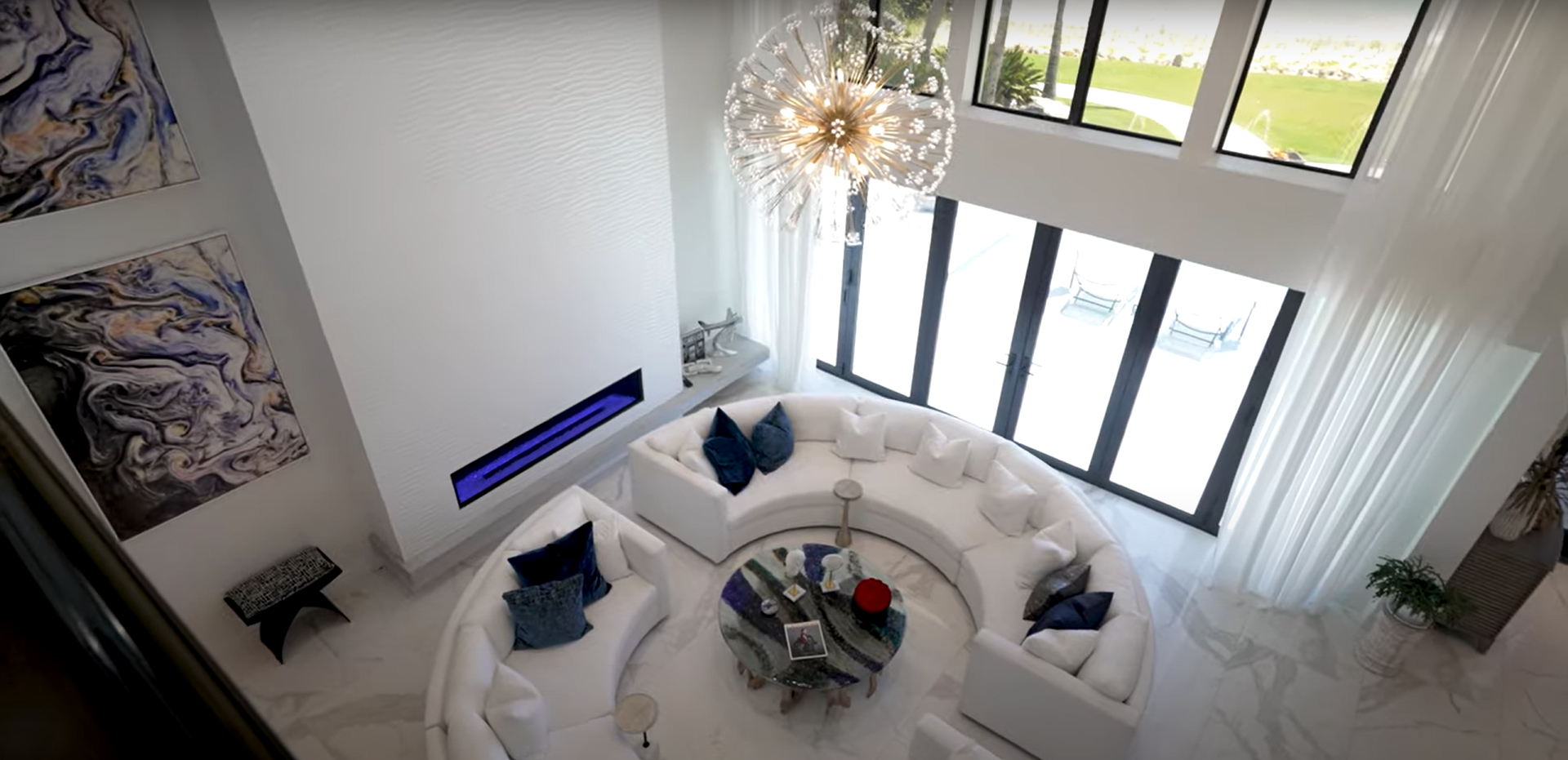 home renovation Vero Beach FL luxury living room with high ceilings modern fireplace and large windows