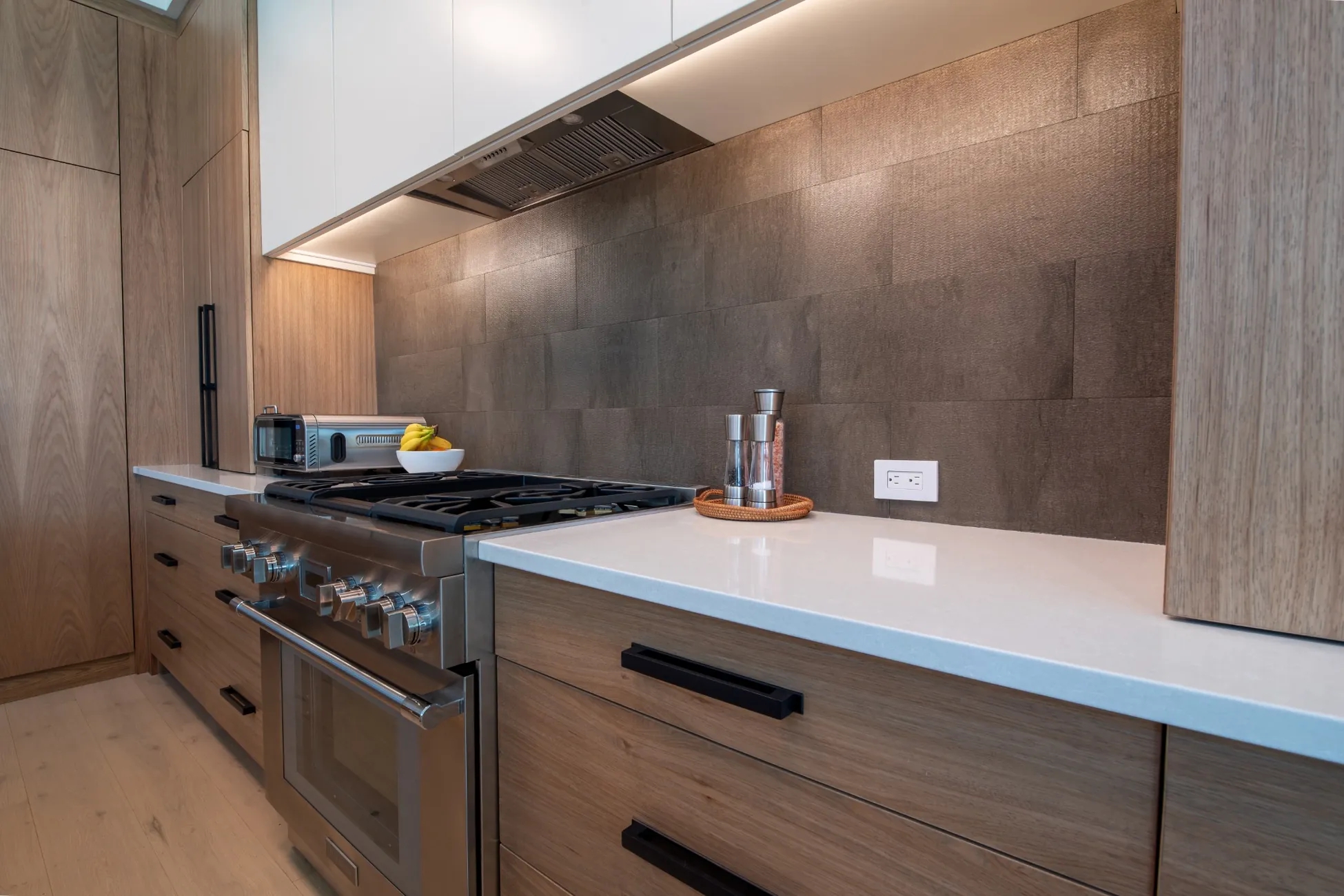 Modern kitchen range with custom backsplash and cabinetry in Vero Beach FL  custom home<br />
