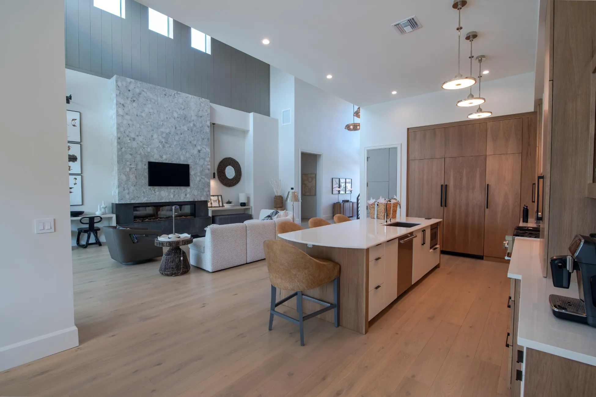 Modern kitchen island with open living room and fireplace in custom home in Vero Beach FL<br />
